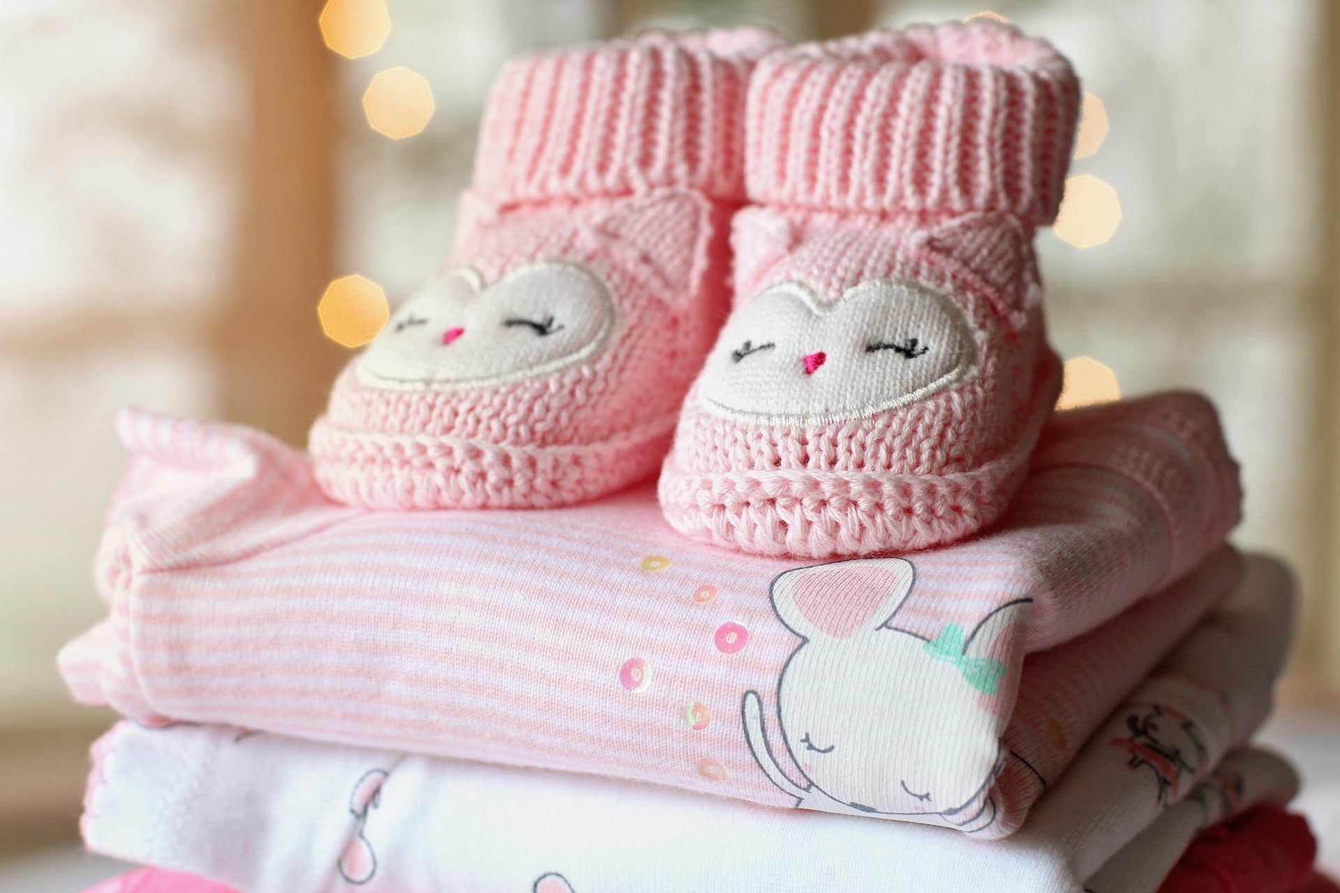baby booties on a stack of blankets